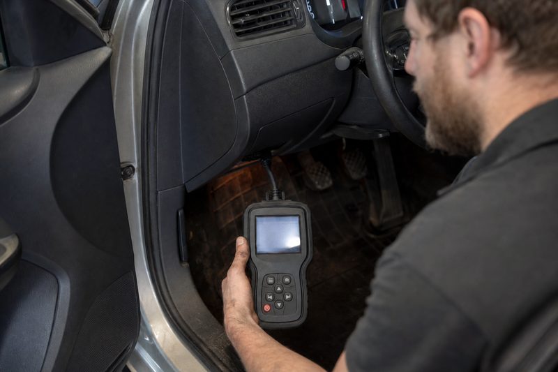 Technician using an OBD scan tool to read trouble codes