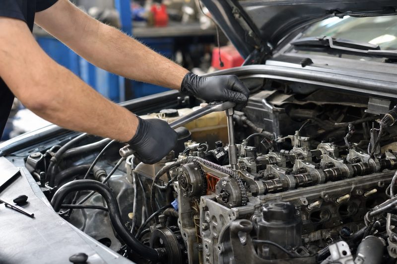 Mechanic performing engine work at ANW Auto Care