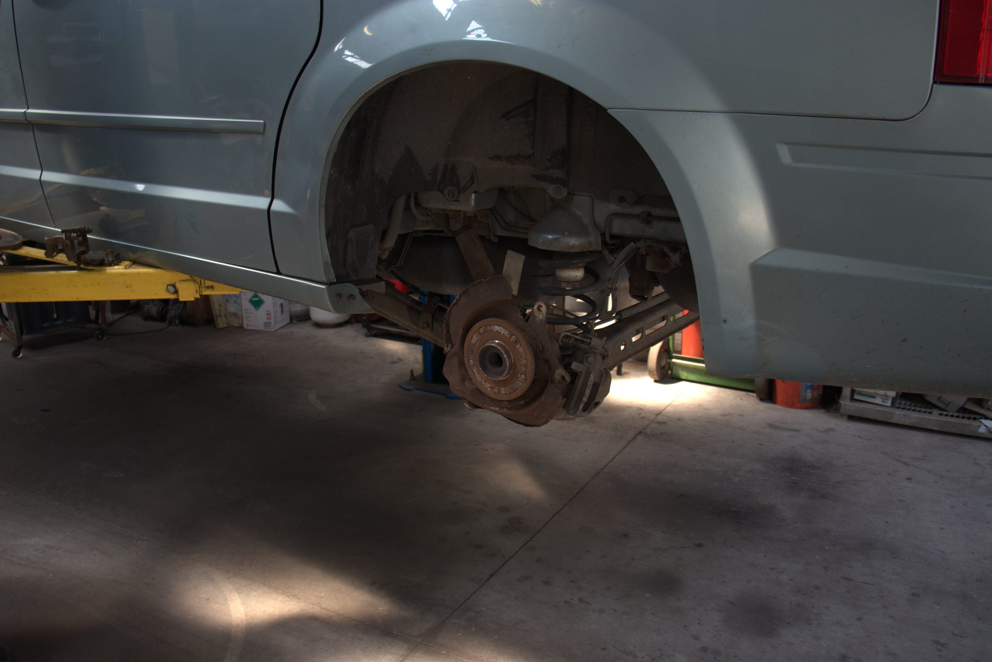 Wheel removed showing rotor and suspension during a brake job at ANW Auto Care