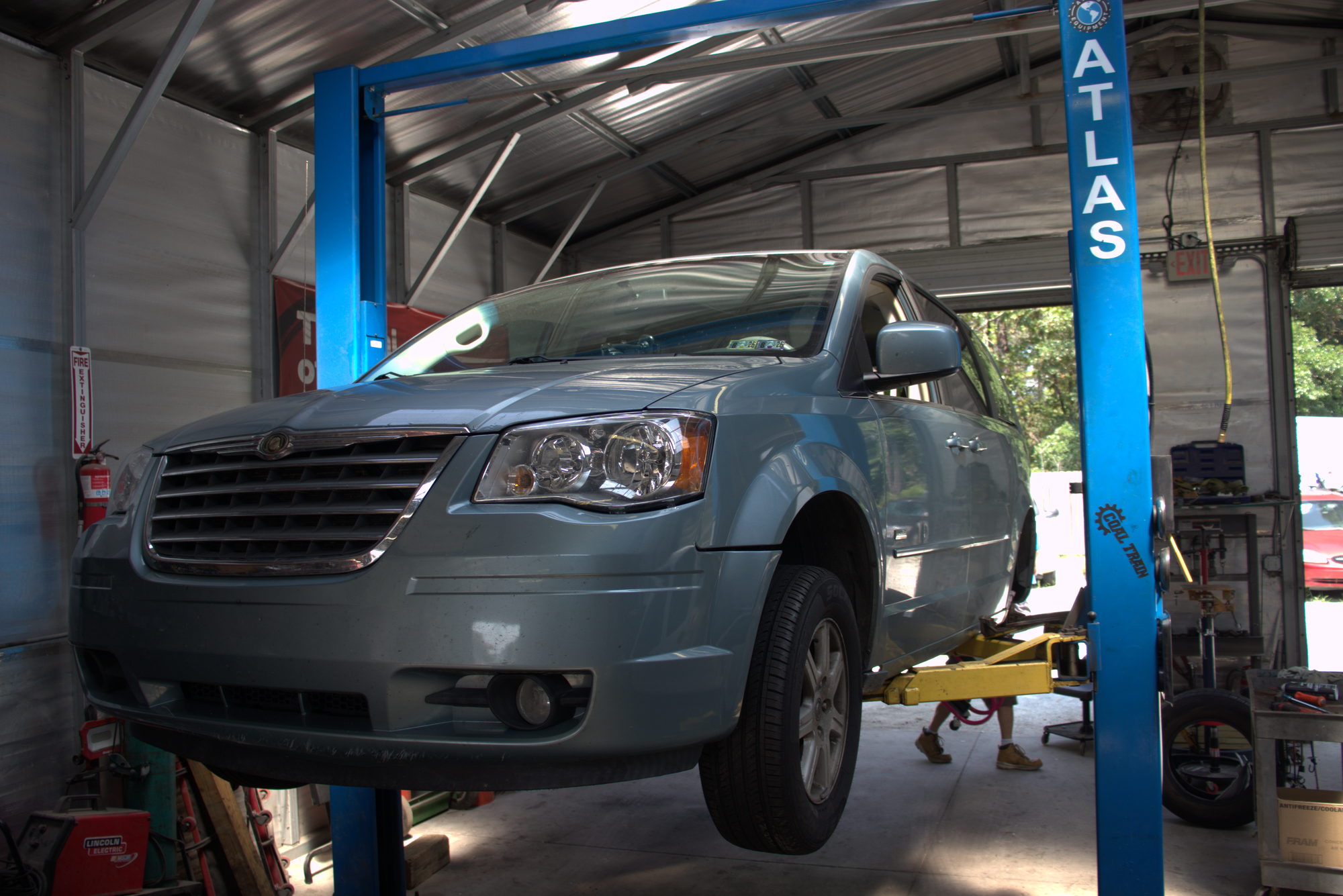 Customer vehicle up on the shop lift ready for service