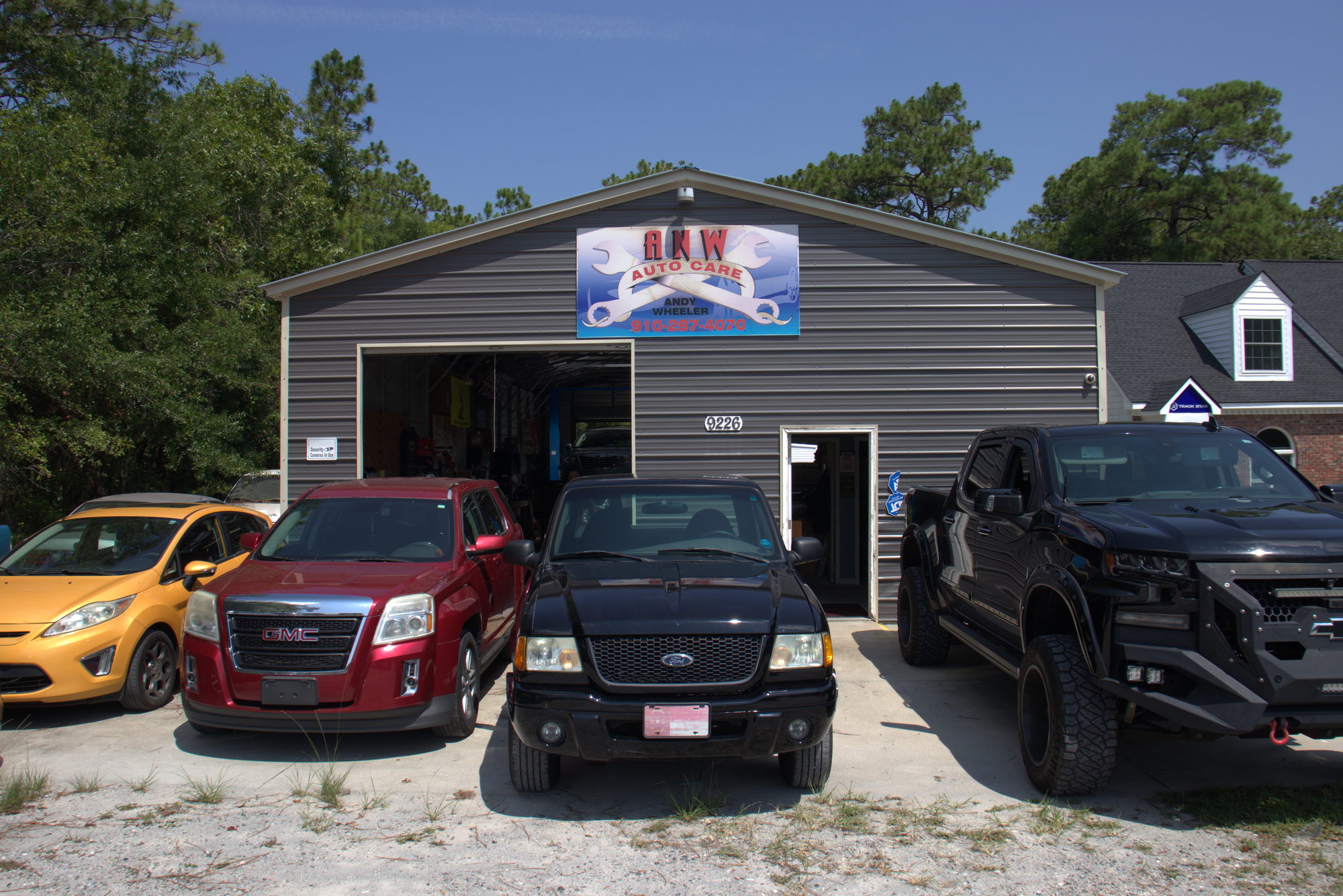 Exterior of the ANW Auto Care shop seen from the parking lot on Beach Drive SW